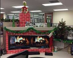 an office cubicle decorated for christmas with a fireplace and decorations on the desks