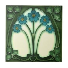 a green and white tile with blue flowers on it