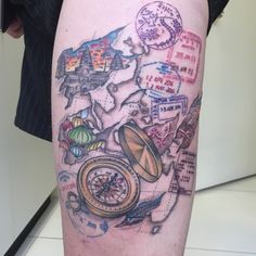 a man's leg with a map and compass tattoo on it