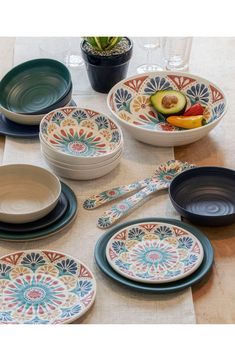 a table topped with lots of plates and bowls