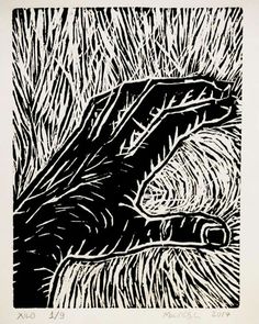 a black and white drawing of an animal laying in the middle of some tall grass