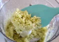 a food processor filled with green and white cake mix in it's glass bowl