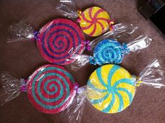 three lollipops wrapped in plastic on the floor