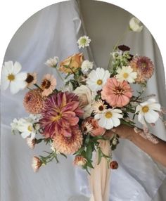 a vase filled with lots of different colored flowers