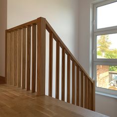 an empty room with wooden stairs and windows