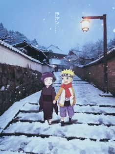 two people walking down a snow covered path