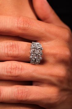 a woman's hand with a diamond ring on it