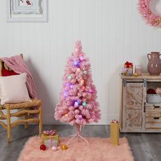 a pink christmas tree in a living room