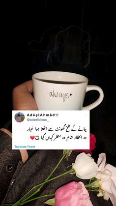 someone is holding a coffee cup with the word always written on it and flowers in front of them