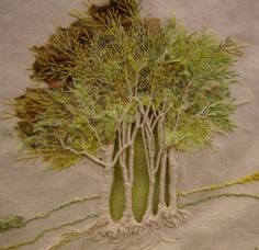 an image of a tree made out of yarn and thread on a piece of cloth