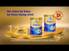 two cans of alpha are sitting on a gold plate with the words, me cham be kheo be khe thong minh