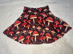 🍄 Our Mushroom Magic Skirt is an adorable piece that's perfect for anyone who loves the whimsical vibes of nature. With its enchanting mushroom print and cottagecore aesthetic, this skirt is sure to bring a touch of magic to your wardrobe. Whether you're dressing up for a festival or keeping it casual for a day out, this skirt offers endless possibilities for expressing your unique style. 🎁 Looking for a special gift? This skirt is a wonderful choice for nature lovers, mushroom enthusiasts, or anyone who appreciates the beauty of the forest. Available in sizes XS - 2XL, it's designed to fit comfortably while showcasing that charming fairycore and forestcore aesthetic we all adore. 🌲 Crafted with care right here in the USA, this skirt is made from a soft and stretchy blend of 95% polyest Mushroom Skirt, Forestcore Aesthetic, Stil Rock, Boho Style Skirts, Skirt Cottagecore, Magic Skirt, Mushroom Magic, Vintage Boho Style, Cottage Core Dress