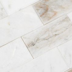 a white marble tile floor that looks like it has been polished