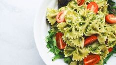 a white plate topped with pasta and vegetables