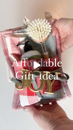 someone holding up a small gift bag with scissors and other items in it that says, adorable gift idea