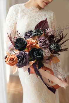 a woman holding a bouquet of flowers in her hands