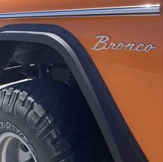 an orange truck with the word bronco on it