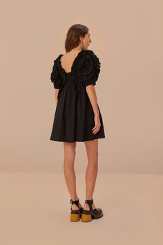 Embrace elegance with the FARM Rio Black Ruffle Short Sleeve Mini Dress, a blend of playful charm and sophistication. This enchanting piece features voluminous ruffled short sleeves and a flattering square neckline that frame the silhouette. Its cinched waist flows into a gentle flare, creating a feminine and airy shape, while the pure black hue lends itself to versatile styling for any occasion. Perfect for those who cherish a touch of drama in their wardrobe essentials. Composition 100% COTTONCare Instructions MACHINE WASH, GENTLE CYCLE, DO NOT BLEACH, DO NOT TUMBLE DRY, LINE DRYING, IRON AT LOW HEAT, DRY CLEAN WITH ANY SOLVENT EXCEPT TRICHLOROETHYLENESize and Fit Inches XXS XS S M L XL Bust 29 1/4 31 33 35 38 1/4 41 1/4 Waist 24 2/4 26 2/4 28 1/4 30 1/4 33 2/4 36 2/4 Length 32 3/4 33 2/ Pure Black, Short Sleeve Mini Dress, Ruffle Shorts, Farm Rio, Black Ruffle, Mini Dress With Sleeves, Cinched Waist, Square Neckline, Dresses Xs