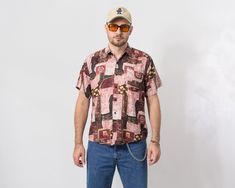 "Vintage 90's short sleeve shirt in printed abstract pattern - collared - button down - pocket on the chest - materials: 100% cotton SIZE size from label: 42 best fits men: S/M MEASUREMENTS chest: 45,5 inches (116 cm) length: 29 inches (74 cm) The model is 6'1\" (186 cm), measures 41-35-39 (104-88-100 cm) CONDITION: The shirt in good vintage condition. Washed, ready to wear." Multicolor Retro Print Relaxed Fit Shirt, Multicolor Vintage Print Shirt, 90s Windbreaker, Vintage Multicolor Graffiti T-shirt, 90s Shorts, Green Raincoat, Multicolor Vintage Print Button-up Top, Windbreaker Jacket Mens, Multicolor Abstract Print Button-up Shirt