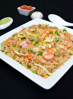 a white plate topped with rice and shrimp