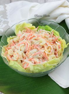 a bowl filled with lettuce and coleslaw on top of a table