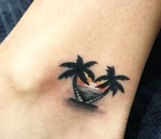 a small palm tree tattoo on the ankle