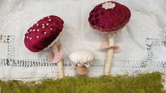 two small stuffed mushrooms sitting on top of a white cloth covered table next to each other