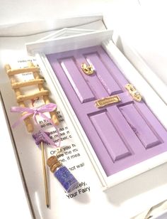 a purple door with some writing on it and a wooden stick sticking out of it