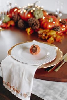 a white plate topped with a piece of fruit on top of a wooden dining table