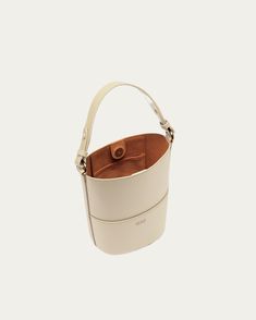 Our darling Bucket Bag is a quintessential piece for every warmer weather wardrobe. Dare we say it’s the ideal home for your phone, keys, lip balm, and favorite pair of sunnies this season (and beyond)? Classic Beige Bucket Bag For On-the-go, Cream Bucket Bag With Removable Pouch For On-the-go, Modern Handheld Bucket Bag For Travel, Luxury Bucket Bag With Mobile Phone Bag For Everyday, Luxury Bucket Bag With Mobile Phone Holder For Everyday, Classic Handheld Bucket Bag For Travel, Handheld Bucket Bag With Dust Bag, Handheld Cream Bucket Bag For Travel, Beige Handheld Bucket Bag For Everyday