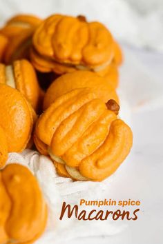 pumpkin spice macarons are on a white cloth with the words pumpkin spice macaroons