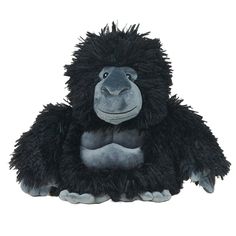 a stuffed gorilla is sitting on the ground