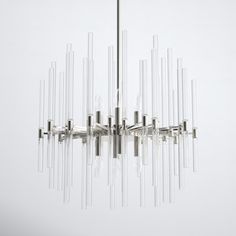 a modern chandelier with clear glass rods hanging from it's center point