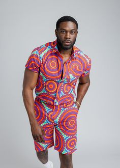 Style#M2015TRC Step out with confidence in our Keyon Men's African Print Button-Up Short Sleeve Shirt in Turquoise Red Circles. This dynamic shirt is a statement piece for the contemporary man who embraces bold style. Shop the matching items. *Disclaimer* Please refer to the fabric image for the true color of this product. Features: Collared Neckline Pocket at Chest 100% Cotton Designed in the USA, imported *Print placement may vary* Care Instruction: Hand Wash Cold. Mild Detergent. Do Not Bleac Short Sleeve Cotton Shirt With Vibrant Print, Cotton Short Sleeve Shirt With Vibrant Print, Vibrant Print Short Sleeve Cotton Shirt, Vibrant Multicolor Short Sleeve Shirt, Casual Red Shirt With Vibrant Print, Casual Fitted Shirt With Vibrant Print, Vibrant Red Short Sleeve Top, African Print Shorts, Bold Style