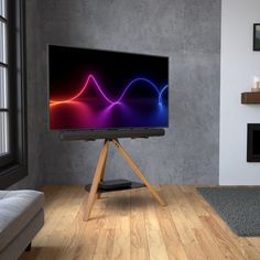 a flat screen tv sitting on top of a wooden stand