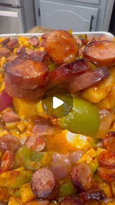 a large pan filled with sausages and peppers