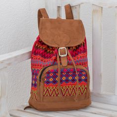 Inspired by the vibrant flowers in the Comalapa region of Guatemala, Mirian Otzin designs this fashionable backpack. She works on a traditional telar de pie, or floor loom, diligently hand-weaving multicolored zigzags and geometric patterns in the style of Mayan textiles. Faux leather accentuates this backpack, which can be worn on two adjustable straps or carried by a handle. A zipper pocket on the front provides space for storing odds and ends. The bag's main flap opens with a belt buckle, rev Backpack Flowers, Cotton Travel Bag, Mayan Textiles, Cotton Backpack, Floor Loom, Outdoorsy Style, Mexican Fashion, Cotton Handbag, Odds And Ends