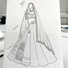 a drawing of a woman's wedding dress in black and white, on a table