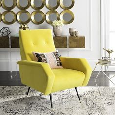 a yellow chair sitting in front of a wall with mirrors on it's side