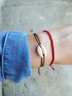 Cowrie shell on cream/black/brown/gray string - a must have beachy bracelet, goes easy with everything:) - Minimalist string bracelet with adjustable sliding closure. - Easy to fit to the wrist due to adjustable size closure. - Extra parts of the closure each measures about 2 inches or shorter on request. - A string bracelet is a symbolic gift to be offered to anyone, as a talisman to protect from negativity. - The string is waxed cotton. - Suitable as an anklet, large size available at checkout Casual Braided Bracelets With Adjustable Length For Beach, Casual Beach Bracelet With Adjustable Cord, Casual Beach Friendship Bracelets With Sliding Knot, Casual Friendship Bracelets With Sliding Knot For Beach, Casual Braided Strand Bracelets As Gift, Casual Adjustable Cord Bracelets For Beach, Casual Braided Strand Bracelet As Gift, Casual Adjustable Cord Bracelet For Beach, Minimalist Handmade Bracelets For Beach