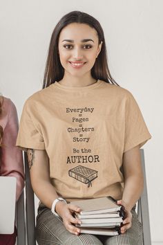 This inspirational t-shirt is perfect for any occasion and makes a great gift for friends and family. Whether you’re shopping for yourself or someone else, this shirt will remind them that they are the authors of their own stories. With its empowering message and stylish design, the “Everyday is a Page Be the Author” t-shirt is the perfect way to express your individuality and let the world know that you are in charge of writing your own story. This t-shirt is everything you've dreamed of and more. It feels soft and lightweight, with the right amount of stretch. It's comfortable and flattering for all. • 100% combed and ring-spun cotton (Heather colors contain polyester) • Fabric weight: 4.2 oz/yd² (142 g/m²) • Pre-shrunk fabric • Side-seamed construction • Shoulder-to-shoulder taping • Bl Bookish Short Sleeve T-shirt With Funny Text, Bookish T-shirt With Funny Text And Crew Neck, Literary Graphic Print Crew Neck T-shirt, Literary Relaxed Fit Crew Neck T-shirt, Relaxed Fit Pre-shrunk Bookish T-shirt, Literary Cotton Relaxed Fit T-shirt, Literary Style Cotton T-shirt With Relaxed Fit, Literary Crew Neck T-shirt With Screen Print, Short Sleeve T-shirt With Funny Text