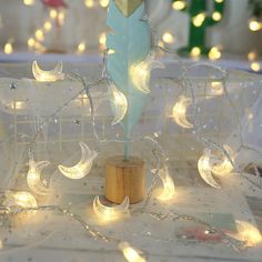 a white christmas tree with fairy lights on it