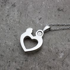 "For the mother who has suffered the worst imaginable loss, the loss of a child, I offer this beautiful urn necklace. The mother and child shaped stainless steel Cremation Urn Necklace includes a beautiful pewter teardrop tag, which is hand stamped, one letter at a time, with the words \"a piece of my heart\", and an infinity heart at the center. It is personalized with the birthstone of your choice. The urn will hold a little bit of your loved one's ashes. There is a screw on the back of the pe Ashes Jewelry Cremation, Ashes Necklace, Cremation Necklaces, Child Loss, Urn Necklace, Ashes Jewelry, Baby Footprints, Infinity Heart, Urn Necklaces