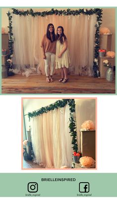 two women standing next to each other in front of a white backdrop with flowers and greenery