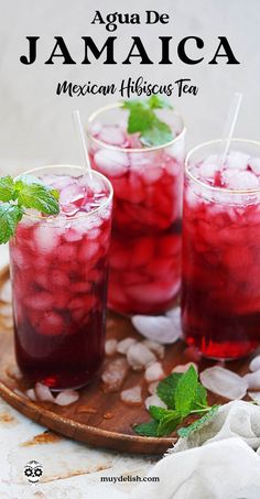 three glasses filled with mexican hibisco tea on top of a wooden platter