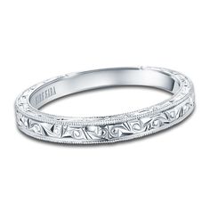 a wedding band with intricate engraving on the sides and an engraved design in the middle