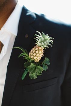 a pineapple boutonniere on a man's lapel