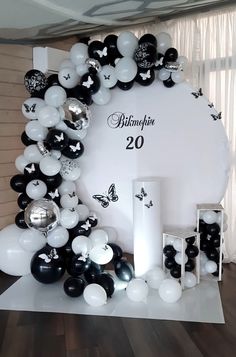 black and white balloons are arranged in the shape of a circle on a display table