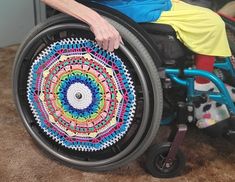 a woman in a wheel chair with a colorful design on it