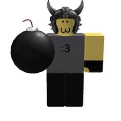 a lego man holding a black ball and an evil mask on top of his head